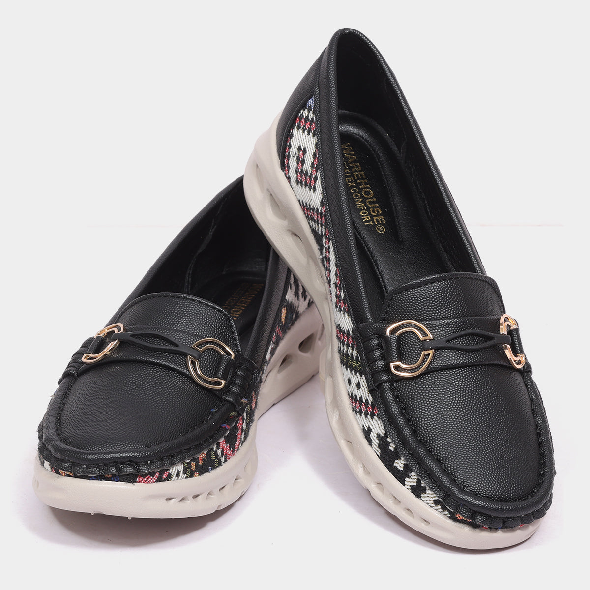 Black woven loafers on feet with beige linen pants - tight crop lifestyle