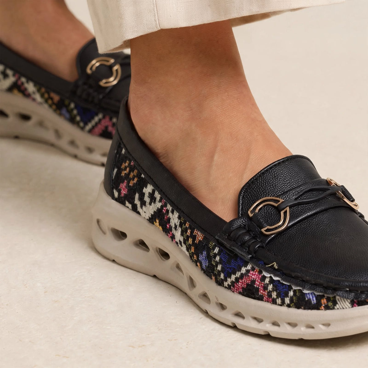 Black patterned loafer shoe with hollow EVA sole and cutouts - close-up